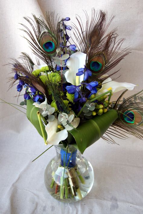 Peacock Bouquet Peacock Flower Arrangement Floral Design, Peacock Feather Flower Arrangements, Peacock Flower Arrangement, Bouquet With Peacock Feathers, Peacock Party Theme, Peacock Wedding Centerpieces, Peacock Wedding Bouquet, Peacock Wedding Decorations, Dark Blue Party