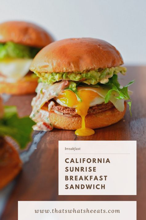 A breakfast sandwich stacked on a brioche bun with drippy egg yolk, avocado, mixed greens, and chicken sausage. Sausage Breakfast Sandwich, California Sunrise, Sunrise Breakfast, Brunch Burger, Breakfast Sandwich Recipes, Avocado Chicken, Breakfast Platter, Breakfast Burger, Breakfast And Brunch