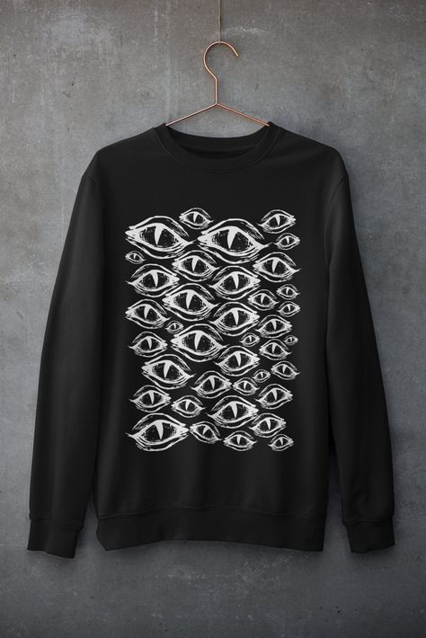 Eyes Goth Sweatshirt Dispatched in 5 working days or sooner Material: 80% ringspun cotton/20% polyester. - Drop shoulder style. - Stylish fit. - Soft cotton faced fabric. - Taped neck. - Ribbed collar, cuffs and hem. ECO-FRIENDLY Each garment is made to order, reducing extra material and energy that would be otherwise wasted We use DTG printing process which is easier on the environment than screen-printing Our ink is bright and also eco-friendly. Do not tumble dry Wash at 30 degrees c inside ou Eye Themed Clothes, Clothes With Eyes On Them, Eco Goth, Goth Sweatshirt, Gothic Sweatshirt, Clothes Pastel, Eye Sweater, Goth Hoodie, Eye Clothes