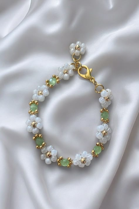 Introducing the exquisite 'Secret Garden' bracelet. This stunning piece of jewellery is designed to complement your outfit with a touch of sophistication. Its beautiful light green color is reminiscent of the natural beauty found in secret gardens. Crafted with attention to detail, this bracelet exudes elegance and style. Its delicate design makes it perfect for both casual and formal occasions, adding a touch of glamour to your look. The 'Secret Garden' e is made from high-quality materials tha Secret Garden Design, Christmas Presents For Women, Christmas Presents For Her, Green Gem, Green Bracelet, Daisy Bracelet, Bracelets Design, Secret Gardens, Floral Bracelet