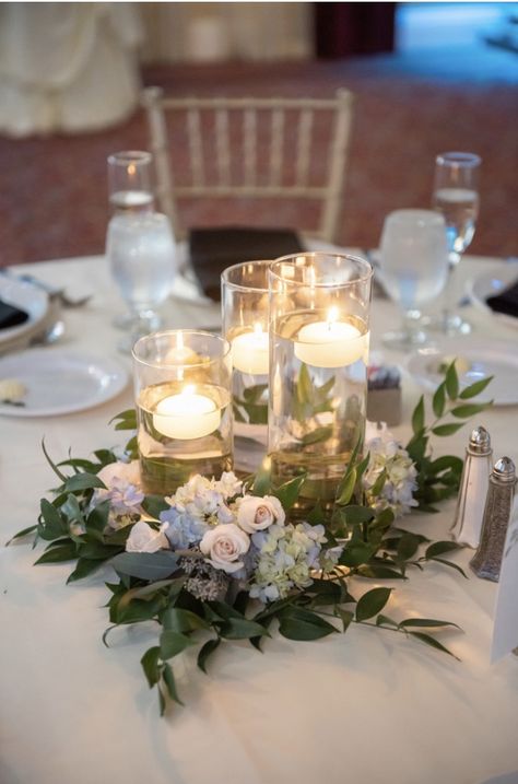 Floating candle wedding centerpiece with greenery and flowers by Eden Events Centerpiece With Greenery, Wedding Centerpeices, Floating Candle Centerpieces Wedding, Floating Candles Wedding, Candle Table Centerpieces, Winter Wedding Centerpieces, Floating Candle Centerpieces, Blue Centerpieces, Wedding Renewal