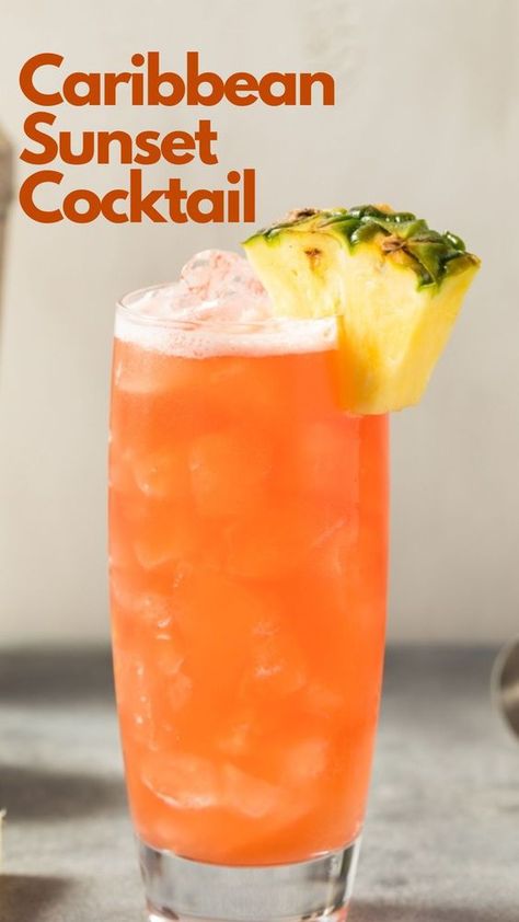 Do you dream of relaxing on a Caribbean beach, watching the sun nestle behind the captivating ocean, but are stuck in any place but there? Then a Caribbean Sunset cocktail may be the answer to your dream. This incredibly light rum drink is effortless to make. Just combine your favorite coconut rum with pineapple juice, a dash of lime juice, and grenadine for aesthetics, and off you drift into your tropical fantasy. #CaribbeanSunsetCocktail Light Liquor Drinks, Rum Drinks With Pineapple Juice, Coconut Rum And Pineapple Juice Drinks, Caribbean Sunset Cocktail, Caribbean Drinks Nonalcoholic, Carribean Drinks Cocktails, Mango Rum Drinks Recipes, Tropical Sunrise Drink, Carribean Cocktails