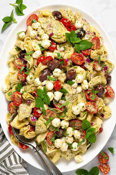 This Pesto Tortellini Pasta Salad is loaded with cheese tortellini, tons of veggies, and plenty of fresh mozzarella - all tossed in a super simple pesto vinaigrette. Whether you need a quick salad for your next backyard barbecue, an easy meal prep recipe, or just something different to lunch today, this tortellini salad will quickly become a family favorite! Bocconcini Pasta, Pasta Salad Tortellini, Pesto Tortellini Pasta Salad, Cold Pesto Pasta Salad, Cheese Tortellini Salad, Salad Tortellini, Salad With Tortellini, Pesto Salad Recipes, Tortellini Pesto