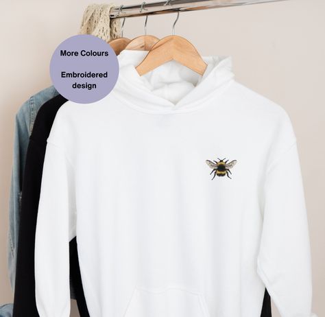 Bumble Bee Embroidered Hoodie, a delightful addition to your wardrobe! This Unisex Embroidered Bee Hoodie is perfect for bee lovers and beekeepers alike, making it an ideal gift idea. Adorned with intricate bee embroidery, this cozy hoodie is not only stylish but also celebrates the beauty of these fascinating creatures. Stay cozy and stylish while showing your love for bees with this unique piece of bee embroidered clothing! . . .. . . #BeeEmbroideredHoodie #BeeLovers #BeeKeepers #BeeFashion... Bee Hoodie, Embroidered Bee, Bee Embroidery, Cozy Hoodie, Embroidered Clothes, Embroidered Hoodie, Bee Keeping, Stay Cozy, Embroidered Design