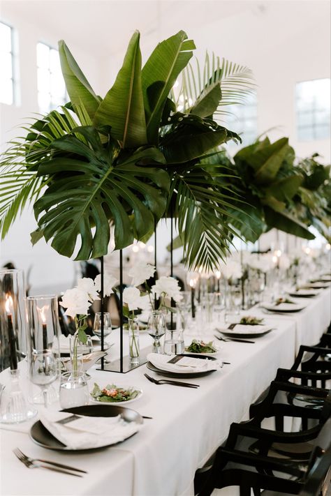 Wedding Flower Arrangements Tropical, Tulum Style Wedding Decor, Large Green Leaf Centerpiece, Monstera Plant Wedding Decor, White Protea Arrangement, Tulum Table Setting, Black White Gold Boho Wedding, Rainforest Themed Wedding, Plant Wedding Reception