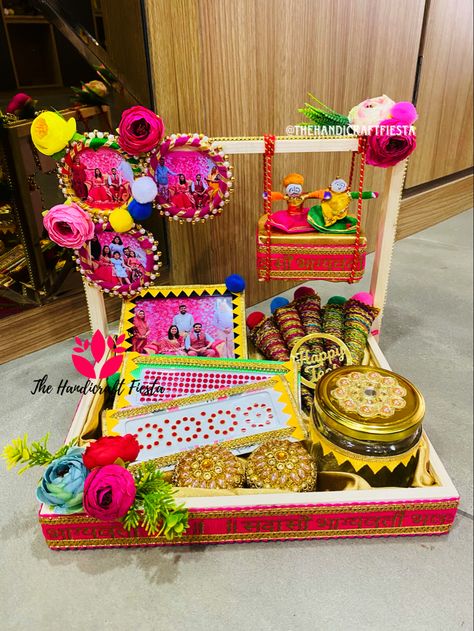 Indulge in the Essence of Teej with Our Perfect Hamper From the elegantbasket to intricate bindi, cute photo frames, bangles, fragrant mehndi cone and a charming sindoor box. Experience the true spirit of Teej/Sinjara in every element. Celebrate Teej in style with these essentials. Order now and elevate your festivities with @thehandicraftfiesta #thehandicraftfiesta #teej #teejspecial #teejfestival #teejmehndi • #teejvibes #bhilwara #teejhampers #hamperforteej #sinjara #explorepage #photograph Hariyali Teej Hampers, Teej Thali Decoration, Hartalika Teej Festival Decoration Ideas, Teej Hamper Packaging, Teej Packing Ideas, Hariyali Teej Decoration Ideas At Home, Teej Sinjara Decoration, Teej Celebration Ideas, Haryali Teej Decoration