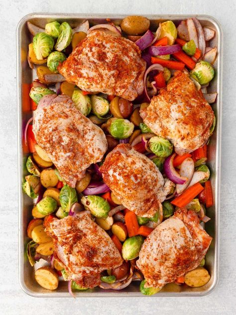 Whip up this Chicken Thigh Tray Bake for a fuss-free meal that's loaded with flavor! With juicy chicken thighs, colorful veggies and a sprinkling of seasonings, everything roasts on one sheet pan for maximum flavor and easy cleanup! Chicken Tray Bake Recipes, Vegetable Bake Recipes, Juicy Chicken Thighs, Sheet Pan Meals Chicken, Chicken Tray Bake, Cubed Sweet Potatoes, Easy Sheet Pan Dinners, Tray Bake Recipes, Sheet Pan Dinners Recipes