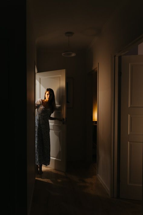 A woman is standing in a dark hallway photo – Free At home Image on Unsplash Night Photography At Home, House Photography Interior, Doorway Photoshoot, Hallway Poses, Photoshoot Inspiration At Home, Woman Opening Door, Home Photoshoot Woman, Hallway Photoshoot, Self Portrait Photography Ideas At Home