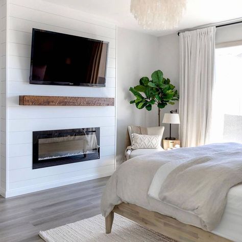 You might be wondering how to get a pristine bedroom design like this. For starters, you can implement a monochromatic theme, install a sleek fireplace, and put a small tree in the corner. Image credit: INSTAGRAM @SOLXROSEHOME Outdoor Electric Fireplace Patio, Diy Electric Fireplace In Bedroom, Patio Electric Fireplace, Electric Fireplace Master Bed, Small Electric Fireplace Ideas, Electric Fireplace In Bedroom, Outdoor Electric Fireplace, Electric Fireplace Bedroom, Small Electric Fireplace