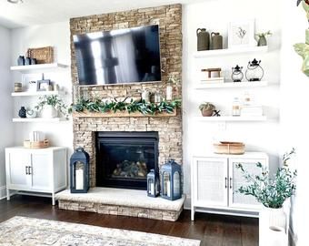 Fireplace With Windows On Each Side Shiplap, Fireplace With Floating Shelves On Sides Stone, Fireplace Shelves Ikea, Floating Shelves Matching Mantle, Shiplap Wall On Sides Of Fireplace, White Floating Shelves Around Fireplace, Fireplace With Marble Tile With White Floating Shelf, Floating Shelves By Brick Fireplace, Brightening Up Wood Fireplace Shelves