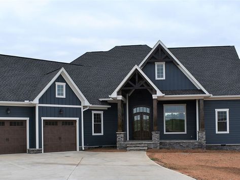 Midnight Blue House Exterior, Navy Blue Vertical Siding, Dark Blue Ranch House Exterior, Dark Blue Home Exterior, Hardie Evening Blue Siding, Dark Gray Exterior House Colors, Blue House Black Trim, Dark Blue House Exterior With Wood Craftsman, Navy Blue Exterior House Colors