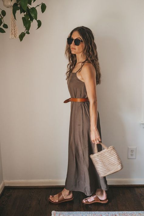 ashley wearing a green slip dress with a brown leather belt tied at the waist, brown leather sandals, and a woven bag with tortoise shell sunglasses Bag Capsule Wardrobe, Summer Capsule Wardrobe 2022, Summer Style 2022, Elevated Outfits, Capsule Wardrobe 2022, Slip Dress Outfit, Green Slip Dress, Summer Capsule Wardrobe, Brown Leather Sandals