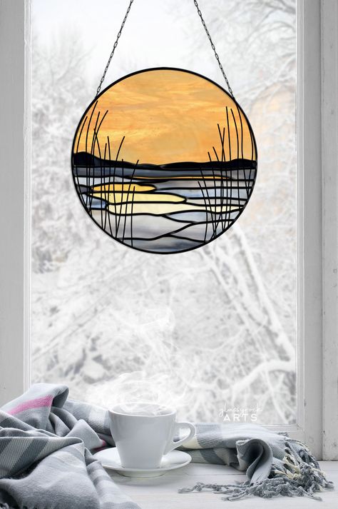 This icy winter marsh landscape stained glass pattern is a digital stain glass pattern for a winter scape or sunet vista landscape light catcher. This mountain suncatcher stained glass PDF download is printable, delivered instantly and prints out on 11x17" tabloid paper. It requires tinned copper wire to complete the "reeds" soldered on the design. Many more details are below!ITEM: This listing is for a *digital pattern* and contains two different versions of this diy stained glass pattern - one Stained Glass Patterns Free Lighthouse, Canoe Stained Glass Pattern, Camper Stained Glass Patterns, New Stained Glass Ideas, Stained Glass Lake Scene, Sea Stained Glass Pattern, Stained Glass Sunset Landscapes, Sunrise Stained Glass Pattern, Stained Glass Decorations