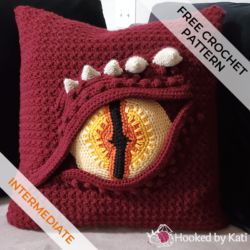 Dragon Eye Pillow | Free Crochet Pattern Crochet Eyeball Pillow, Yamaka Crochet Pattern, Crochet Dragon Pillow Pattern Free, River Otter Crochet Pattern Free, Free Crochet Lord Of The Rings, Dragon Crochet Blanket Pattern, Dragon Eye Pillow Crochet, Crochet Dragon Pillow, Crochet Dragon Stitch