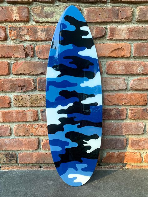 Contact us to order yours now!! 🎨 #coreypaige #coreypaigedesigns #coreypaigestudio #pinkhearts #forsale #artforsale #painting #murals #womeninbusiness #femaleartist #painter #artist #illustration #illustrations #graphicart #camo #graffitiartist #bluecamo #surfboard #painting #resin Painted Surfboard, How To Paint Camo, Surfboard Painting, Painting Resin, Painter Artist, Artist Illustration, Blue Camo, Graffiti Artist, Hand Painted Artwork