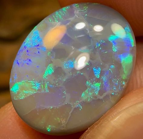 An beautiful, Gem quality, solid Black Opal from Lightning Ridge, New South Wales. Displaying blue and green colouration in flag and chaff patterns. Cut to a highly desirable oval cabochon. A great size to make a large ring or pendant. Total weight - 9.7cts Area of Mine - Lightning Ridge, New South Wales, Australia Dimensions - 17.1mm x 13.5mm x 6.5mm Shape - oval  Colours - green, blue Extras - Free International Airmail / shipping automatically applied when purchasing this item and/or bundling with any other purchase.