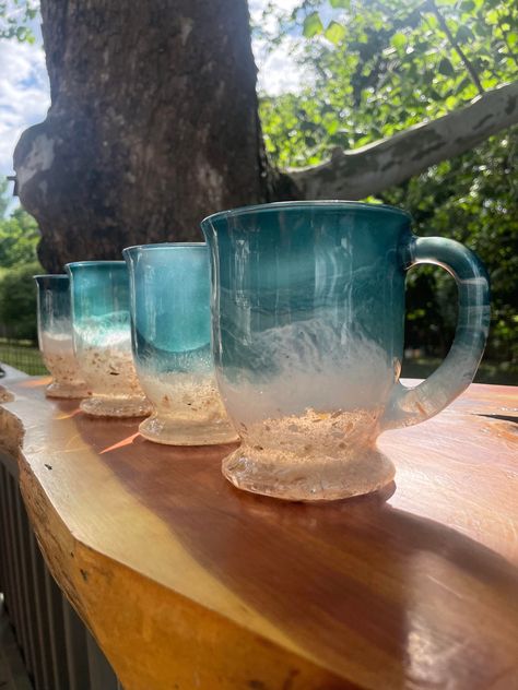 Sip in Style with a made to order, hand poured resin glass. Beach Inspired Coffee Mug made with REAL SAND These glasses make the most PERFECT gift - housewarming, new mom, closing gifts, anniversary, loss of loved one, thinking of you, mothers day. The feedback we receive is a clear indicator that everyone is LOVING these mugs :) ✰ Glass Dimensions #1 Large Wide Mouth Glass Mug- 3 finger hold 4.25'' W x 3.56'' T (Holds 16 oz.) BEST SELLER #2 Beer Can Glass no handle- 6 3/8 in. Tall (Holds 16 oz.) #3 Tall Mug large handle - 3'' W x 4.7'' T (Holds 16 oz.) #4 Medium Tall Mug 3.25'' W x 4.25'' T (Holds 10.75 oz.) #5 Original Glass Mug 3.7'' high x 3.3'' in diameter with a 3.3-inch base (Holds 13 oz.) #6 Stemless Glass 2.75 x 2 x 4.62 inches (Holds 20 oz.) BEST SELLER #7 Stemless Acrylic 2.75 x Coffee Mugs Unique, Clear Glass Coffee Mugs, Apple Crisp Recipes, Glass Beach, Mug Warmer, Wine Cup, Glass Coffee Mugs, Gift Housewarming, Gifts Anniversary