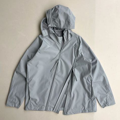 7.0 TECHNICAL JACKET CENTER (LIGHT GREY)  Based on 4.0 TECHNICAL JACKET CENTER, with improved fabric, hem and cuff details. Asymmetric line design from hood to hem with 2-way zippers, offering various styling options. Japanese imported fabric. Membrane coated water repellant and durable 2 layer fabric. 2 YKK 2-way coil zippers at front. 2 YKK zipper pockets at front. Half elasticated cuff at wrist. Hem adjustment system with elastic string and logo engraved stopper. Raglan sleeves. Technical Windbreaker With Adjustable Hood, Technical Hooded Outerwear With Reflective Details, Technical Outerwear With Double-lined Hood And Long Sleeve, Technical Moisture-wicking Hooded Outerwear, Functional Nylon Outerwear With Double-lined Hood, Cuff Detail, 2 Way, Line Design, Raglan Sleeve