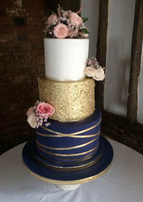 Lisa, 3 tier navy blue and gold theme wedding cake with gold sequin tier and fresh flower decorations Navy And Blush Cake, Gold And Navy Wedding Cake, Navy Blue Gold Wedding Cake, Wedding Cakes Blue And Gold, Navy Gold Party Decorations, Navy Blue Gold Cake, Gold And Blue Wedding Cake, Navy Gold Wedding Cake, Navy Blue And Champagne Wedding Cake