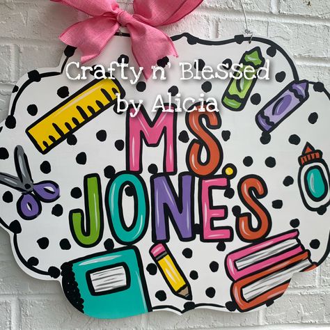 "All our door hangers are designed and hand painted by me! They can be completely customized to YOU! Colors and wording can be changed.  MEASUREMENTS: 22\" WIDE They are hand painted on 1/2\" plywood with acrylic paint and sealed with a clear gloss. Ribbon may vary depending on availability. These are NOT ready to ship/pickup, they are all made to order and you can see our current turnaround time on our main shop announcement page.  We also offer free local pickups. For Georgetown, KY Pickup whe Teacher Plaques Signs, Door Hangers Diy Easy, Door Hangers For Teachers, Classroom Door Hangers, Painted Clipboards, Funky Letters, Painted Door Hangers, Painted Banners, Georgetown Ky