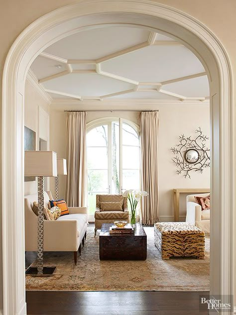 An arched opening leads to a formal living room outfitted with a contemporary mix of furnishings. Here, the classic shape of the simple arch and clean lines of the opening’s inset panels take precedence over elaborate carvings. The ceiling displays a geometric painted plaster relief of skewed octagons connected by rectangles. False Ceiling Living Room, Ceiling Treatments, Living Room Ceiling, False Ceiling Design, Kids Interior, Diy Interior, Coffered Ceiling, False Ceiling, Ceiling Beams