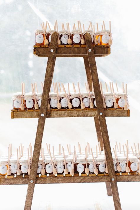 To emphasize their love of cooking, this couple let these jars of honey stand out on an understated wooden stand. Wedding Favors For Men, Favor Display, Bottle Opener Favors, Honey Wedding Favors, Honey Jars, Creative Wedding Favors, Inexpensive Wedding Favors, Winter Wedding Favors, Pooh Birthday