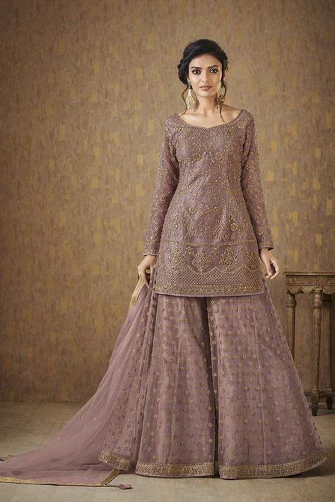 Make a stunning impact wearing this flattering dusty mauve designer palazzo suit falling in a straight cut pattern, worked all over in royal zari & stone embellishments followed by same work different style border in a divine finish! This suit is accompanied by matching palazzo pants with buttis & plain net dupatta. Plazo And Kurti, Umbrella Plazo, Net Kurti, Anarkali Salwar Suits, Designer Palazzo, Palazzo Dress, Indian Kurtis, Umbrella Dress, Kurti Dress