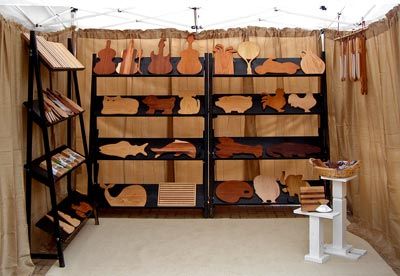 Improved Art Show Booth:  Fantastic article on booth improvement!  Replace tables with shelves or pedestals, use walls, use height, declutter. Craft Show Walls, Art Show Booth, Angled Shelves, Art Festival Booth, Craft Fair Vendor, Art Booth, Craft Fair Booth Display, Craft Show Booths, Shelf Units