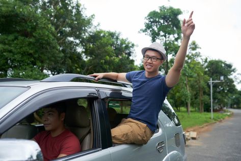 Asian man driving car and cheerful friend sitting in window of rear door | Free Photo Man Driving Car, Leaning Out, Asian Man, Driving Car, Sit Out, Man Sitting, Asian Men, Free Photo, Car Window