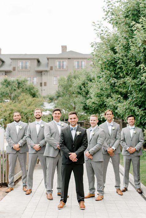 black tux groom grey groomsmen attire Groom Black Tux Groomsmen Grey, Groom In Black Suit Groomsmen In Grey, Black Groom Suit With Grey Groomsmen, Grooms Man Outfits Groomsmen, Groom Wearing Different Color Suit, Black And Grey Suit Men Wedding, Charcole Suits Wedding, Groomsmen Attire Black And Blue, Groomsmen In Grey Suits