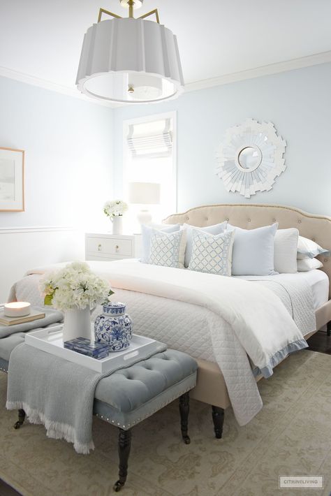 Pale Blue Cream Bedroom, Quilted Bed Back Design, Calming Feminine Bedroom, Blue White Cream Bedroom, Blue Bedding Master Room, Blue Bedroom Pillows, White Bed With Blue Accents, Bedroom With Hints Of Blue, Tan White And Blue Bedroom