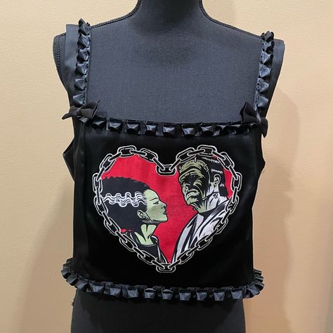 New With Tags Universal Monsters X Dolls Kill Brand Black Satin Crop Top With Shoulder Straps Marked Women’s Size Xxl. This Cute Top Has Ruffles And Bows And Features A Heart On The Front With Frankenstein And The Bride. Can Be Worn As A Top Or Layered Over Another Shirt, Blouse, Or Dress As A Corset Like Top. From A Smoke And Pet Free Home. Frankenstein And The Bride, Rose Bride, Fashion Bible, Clothing Reference, Goth Halloween, Satin Crop Top, Universal Monsters, Bride Of Frankenstein, Cute Top