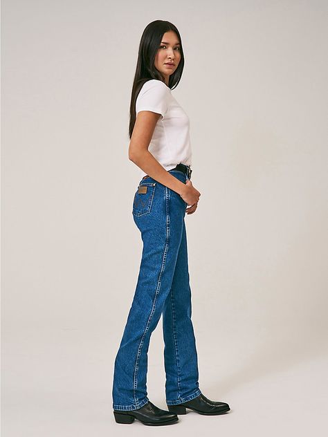 WESTERN STYLING FOR A FEEL-GOOD LOOKThe 14MWZ women's Western jeans have a home in the closets of cowgirls across the country. Made of heavyweight broken twill denim, our women's Cowboy Cut® jeans are designed for comfort and durability in competition, daily chores, and everyday life. These women's jeans come fully equipped with all the iconic features you know and love, including a rope logo patch, gold rivets, 7 belt loops, and a riser label. Best of all, this vintage cotton jean features a super high rise that sits at the natural waist and a tapered leg that fits perfectly over cowgirl boots.  How do these jeans fit?  The vintage fit has a narrow waist, a snug seat, and a slim thigh. The leg opening is wide enough to fit over a pair of cowboy boots.  I have these jeans and love them. If Wrangler Jeans Women's Outfit, Wrangler Jeans Women's, Cowboy Cut Jeans, Bootcut Jeans Outfit, Wrangler Cowboy, Wrangler Cowboy Cut, Daily Chores, Western Jeans, Indigo Jeans