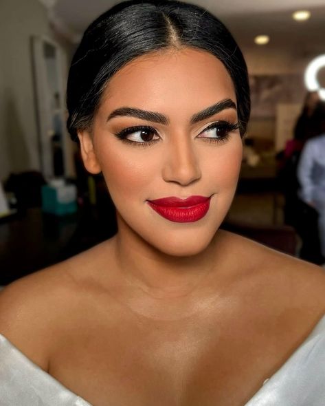 Should brides wear red lipstick on their wedding day? 💄 Absolutely! Here’s why: 👇🏼 ✨ Timeless Elegance: Red lipstick adds a touch of timeless elegance, creating a classic and sophisticated look that shines in wedding photos. ✨Confidence Booster: The boldness of red lipstick can boost your confidence, making you feel empowered and glamorous on your special day. ✨Striking Contrast: Red lipstick creates a striking contrast against a white wedding dress, adding a pop of color that highlights ... Indian Red Lipstick Makeup, Dark Red Lipstick Wedding Makeup, Formal Makeup With Red Lipstick, Bridal Lip Color, Makeup For A Red Dress, Eyeshadow With Red Lipstick, Radiant Skin Glow, Bridal Hmu, Red Lipstick Makeup Looks