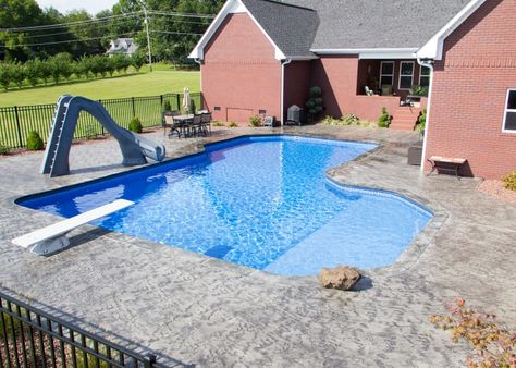 Inground Pool Photo Jonesboro | Gunite Pool Cape Girardeau | Union City - Somerset Grecian Vinyl Inground Diving Pool with Corner Step, Tanning Ledge, Slide, Concrete Coping, and Custom Patio(1) Inground Pool With Diving Board, Vinyl Pool With Tanning Ledge, L Shaped Pool With Tanning Ledge, Inground Pool Slides, Pool With Tanning Ledge, Vinyl Pools Inground, Pool Layout, Cocktail Pool, Tanning Ledge Pool