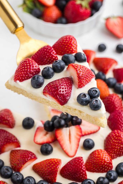 This 4th of July fruit pizza has an easy sugar cookie crust, creamy cheesecake topping, and a burst of fresh berries. This patriotic dessert is as delicious as it is festive and is perfect for any July 4th, Memorial Day, or summer gathering. You can make it traditionally or with gluten-free flour. 4th Of July Sugar Cookie Pizza, Patriotic Sugar Cookie Pizza, Fruit Pizza Graham Cracker Crust, Fruit Pizza American Flag, Sugar Cookie 4th Of July Dessert, 4th Of July Dessert Pizza, 4th Of July Sugar Cookie Fruit Pizza, Fruit Pizza Fourth Of July, Sugar Free 4th Of July Desserts