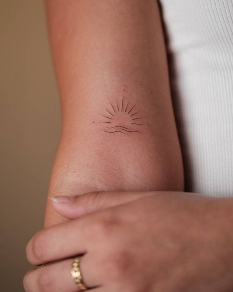 Fine line minimalistic sea sunset tattoo located on the There Is Hope Should Oceans Rise Tattoo, The Sun Always Rises Tattoo, Sunset Wave Tattoo, Arm Minimal Tattoos For Women, Cross And Sun Tattoo, 1 Inch Tattoos For Women, Travel Tattoo Minimalist, Tattoo Ideas Female Dainty, Brown Ink Tattoo On Dark Skin