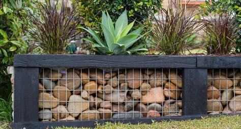 Replace a damaged old garden wall with this rock-steady option! Rock And Metal Retaining Wall, Rock And Wire Retaining Walls, Wood And Stone Retaining Wall, Garden Wall Ideas Brick And Fence, Rock Wire Fence, Retaing Walls Landscape, Gabion Walls, Garden Landscaping Design Ideas, Fire Circle