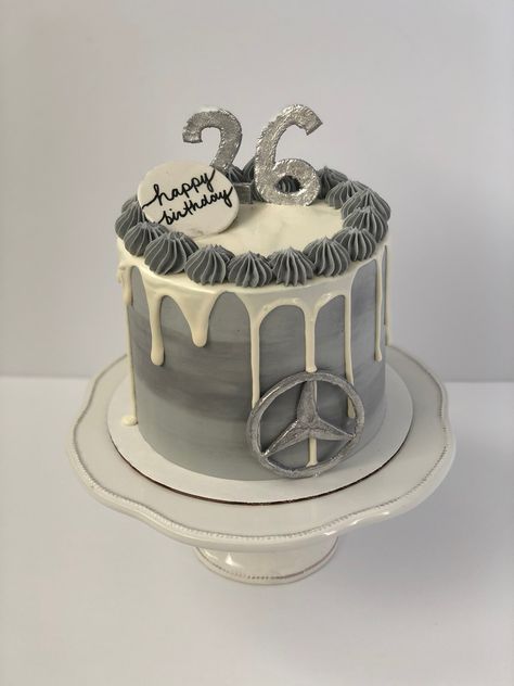 Grey cake with white drip. Swirls of buttercream surround the top of the cake with a silver “26” in the middle and a happy birthday plaque. On the bottom right is a silver Mercedes logo. Cakes For Men 26th Birthday, Cake For Car Lover Men, Mercedes Cakes For Men, Mercedes Benz Cake Ideas, Car Cake Ideas For Men, Mercedes Cake Birthdays, 26 Birthday Cake For Him, Car Theme Cake For Men, Cake For Car Lover