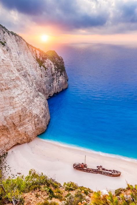 During your stay at Paliokaliva village, don't miss the chance to visit Navagio beach, because after all, all you need is sand, sun, turquoise waters and a ship fable ⚓ 🕵️‍♀️ Greece Country, Navagio Beach, Greek Islands Vacation, Zakynthos Greece, Places In Europe, Menorca, Shipwreck, Beautiful Places To Travel, Greece Travel