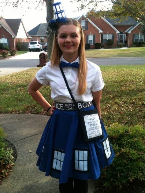 Dr Who TARDIS costume. Made with a blue circle skirt, the windows are white felt with black  ribbon, and just tacked on for easy removal. I found the cool fabric at Spoon flower for the belt and the purse. My awesome sister made the headband out of a painted clear cup.  You can't tell from the photo but I had little LED battery lights that I put in the cup. Tardis Costume, Doctor Who Costume, Tardis Cosplay, Who Costume, Tardis Dress, Doctor Who Outfits, Doctor Who Party, Doctor Who Cosplay, Doctor Who Costumes