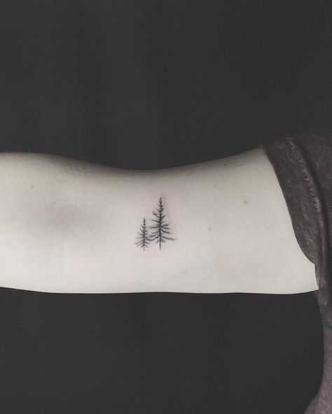 100 Of The Best Small Tattoos - Tattoo Insider Pine Tree Tattoo On Back, North Woods Tattoo Ideas, Mens Nature Tattoo Simple, Mini Pine Tree Tattoo, Grounding Tattoos For Women, Pretty Tree Tattoo, Tree Symbol Tattoo, Small Wilderness Tattoo, Minimalistic Tree Tattoo