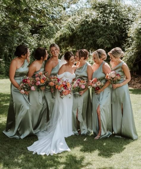 sage green bridesmaids dresses with colorful flowrs in light pink, yellow & white Sage Green Bridesmaid Dresses Colorful Flowers, Flowers For Sage Green Bridesmaid Dresses, Green Bridesmaid Dresses Colorful Flowers, Outdoor Wedding Party Outfit, Sage Wedding Colors Groomsmen, Sage Green Bridesmaid Dresses With Wildflowers, Soft Green Bridesmaid Dresses, Green Wedding With Pop Of Color, Groomsman Colors