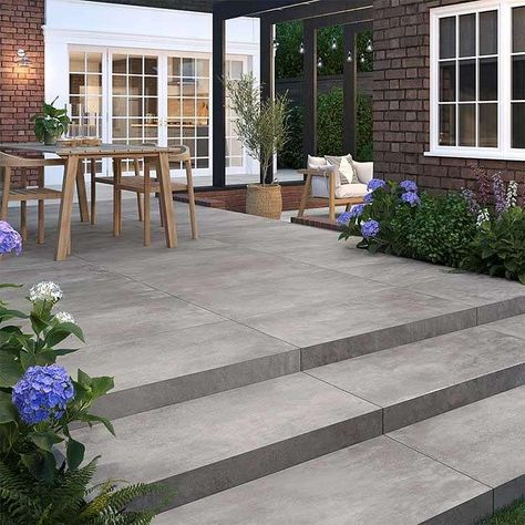 Berkley Anthracite brings a serene industrial vibe to the outdoors, in a fashionable dark shade that replicates the look of concrete.  These outdoor porcelain tiles are easy to install, hardwearing and durable, and will create a sophisticated, trendy look to your exterior space.  Also available in a 900x900mm size. Outside Flooring Ideas, Outdoor Paver Patio Ideas, Outdoor Patio Tile Ideas, Patio Tiles Outdoor Flooring, Garden Patio Designs, Outdoor Flooring Ideas, Patio Door Window Treatments, Porcelain Patio, Garden Redesign