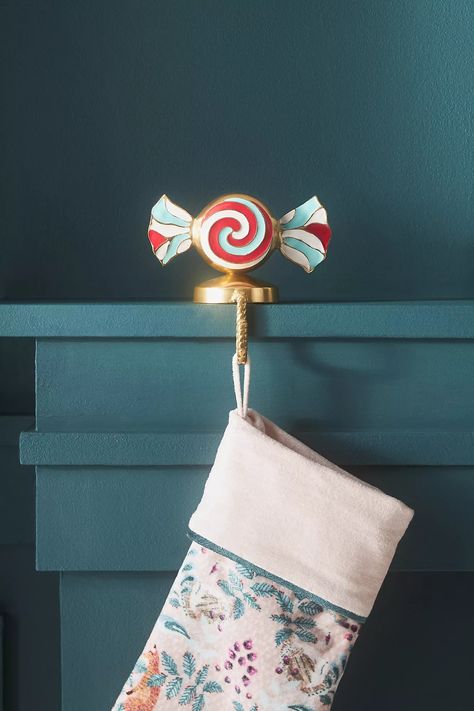 Peppermint Candy Metal Stocking Holder | AnthroLiving Anthropologie Holiday, Christmas Party Themes, Stocking Holder, Christmas Stocking Holders, Cute Stockings, Fortnum And Mason, Christmas Mantle, Stocking Holders, Whimsical Christmas