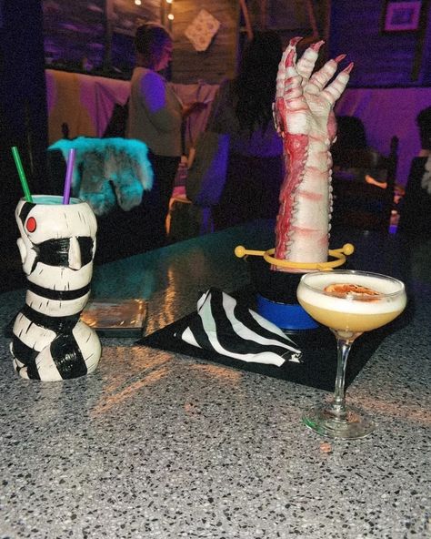 calling all beetlejuice lovers! 👻✨ @hiddenbarnashville has brought the iconic world of beetlejuice to life with killer themed drinks and spooky decor that’ll have you saying, ‘it’s showtime!’ 🍸💀 make sure to swing by before the spooky season ends. trust me, this is one haunt you won’t want to miss! 🎃🎥 Themed Drinks, Shrimp Cocktail, Spooky Decor, Beetlejuice, Spooky Season, To Miss, Trust Me, Drinks, Bring It On