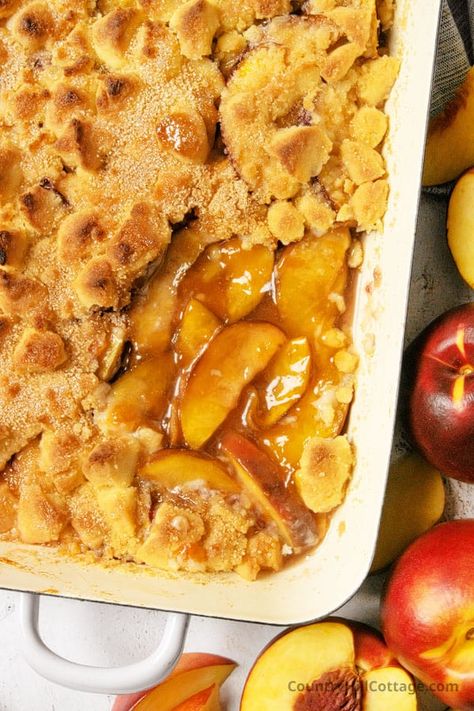 This homemade nectarine cobbler is the best summer dessert ever! Loaded with fresh nectarines and a buttery topping that bakes like cookie dough, this cobbler recipe is super easy to make from scratch and will be a hit with your family. This easy nectarine cobbler recipe comes together in just a few minutes. Add a scoop of vanilla ice cream and you’ll be in heaven! Customize the recipe with blueberries, raspberries, blackberries, strawberries, or use peaches. | CountryHillCottage.com Nectarine Dessert, Nectarine Cobbler, Cobbler With Bisquick, Recipe With Blueberries, Nectarine Recipes, Cobbler Recipes Easy, Best Summer Desserts, Cobbler Easy, Strawberry Cobbler