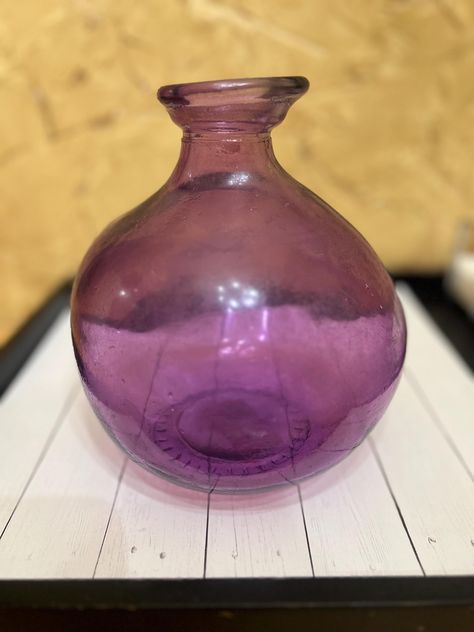 Add a touch of vintage charm to your home decor with this collectable round purple glass bottle. The bottle stands at 8 inches tall and measures 6 inches in length, making it a perfect addition to your decorative pottery and glassware collection. Crafted from high-quality glass, this vintage bottle features a beautiful purple color that will complement any interior design. Whether you're looking to add a touch of elegance to your living room or want to display your collection of decorative items, this vintage glass bottle is a great choice. Bottle Stand, Vintage Bottles, Vintage Bottle, Glassware Collection, Decorative Pottery, Purple Glass, Window Decor, Glass Bottle, Decor Vintage