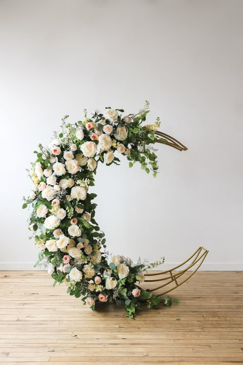 Fully decorated in florals, metal crescent-moon shaped arch backdrop. Diy Moon Arch, Moon Flower Arrangement, Moon Floral Arrangement, Moon Theme Wedding, Flower Arch Decor, Moon Wedding Arch, Moon Wedding Theme, Moon Photoshoot, Sailor Moon Theme