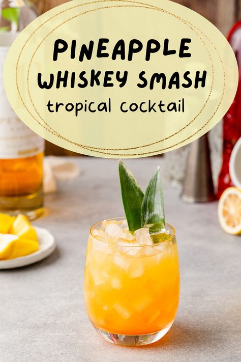 Side view of pineapple bourbon smash cocktail with pineapple frond garnish and the overlay text "pineapple whiskey smash tropical cocktail". Pineapple Whiskey Sour, Pineapple Bourbon Cocktail, Hawaiian Brunch, November Meals, Summertime Cocktail, Whiskey Smash, Pitcher Cocktails, Bourbon Smash, Bourbon Recipes